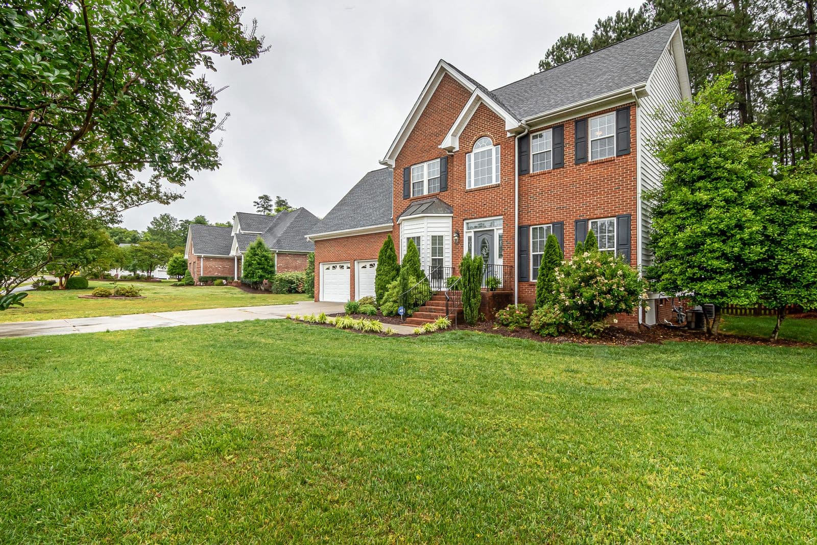 Manicured front lawn of a brick house