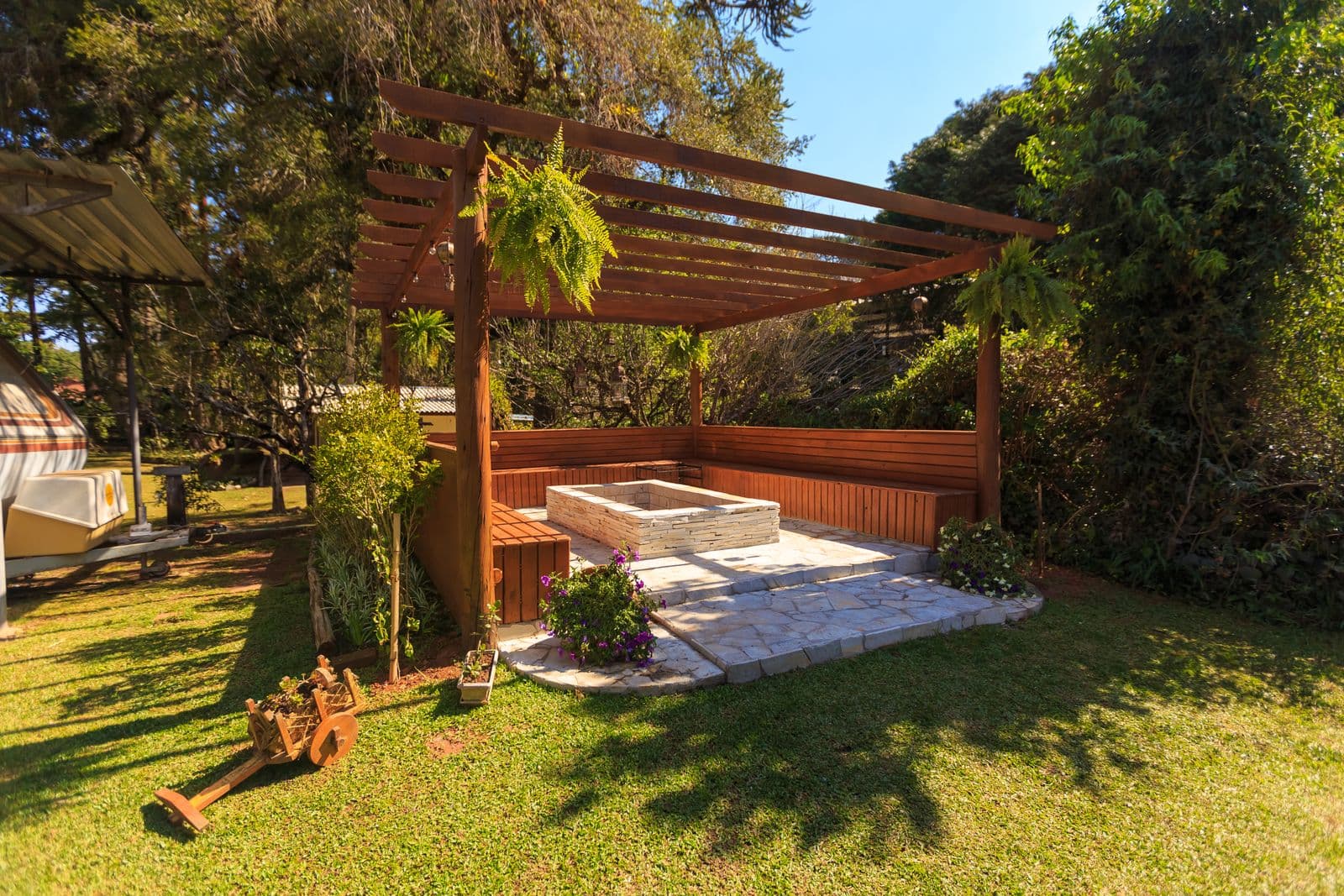 Wooden gazebo surrounded by garden beds