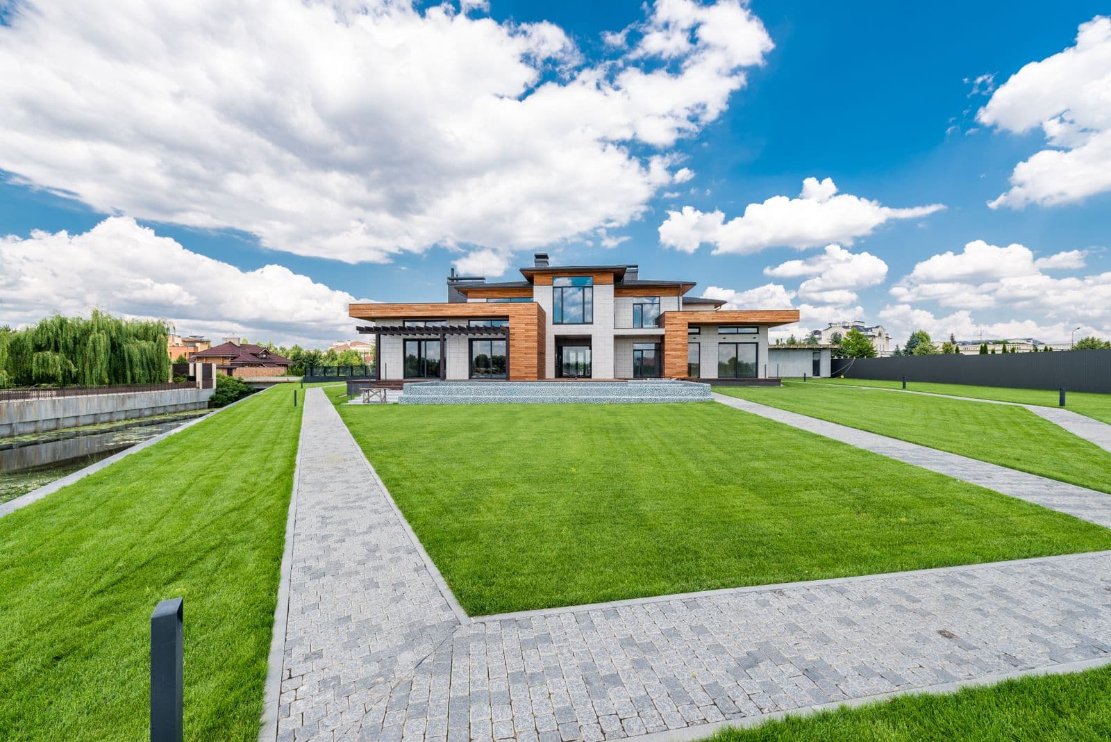 Paver walkway through a landscaped yard