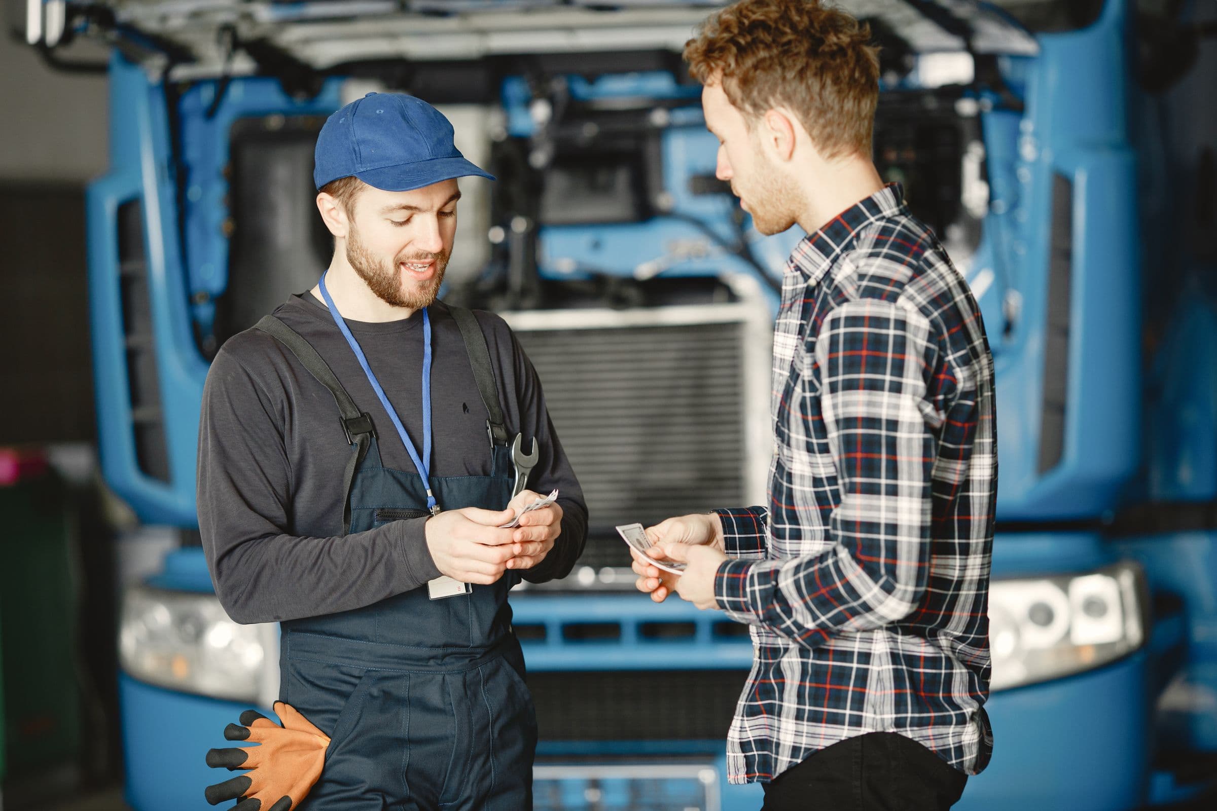 A mechanic talking through a repair with a customer